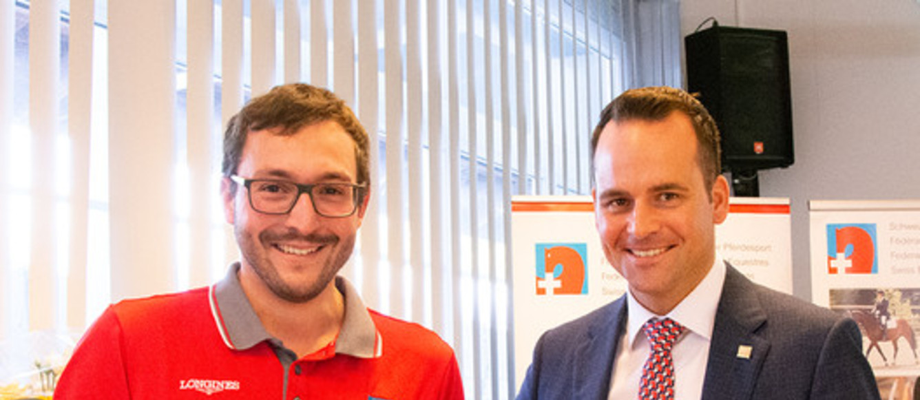 Cédric Scherrer reçoit l'aiguille d'honneur d'or de la FSSE pour ses succès dans le sport d'attelage, remise par le président de la FSSE Damian Müller (Image : FSSE/Nadine Niklaus)