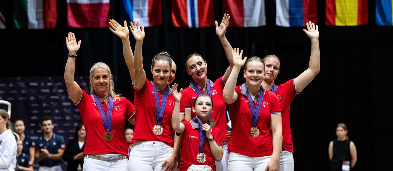 FEI Vaulting World Championship for Seniors and European Championships for Juniors and Young Vaulters, Bern 2024, SwitzerlandBronze Team Switzerland reacts on the podium at the Senior Squads prize giving ceremony in FEI Vaulting Championships in Bern, Switzerland, July 19, 2024.